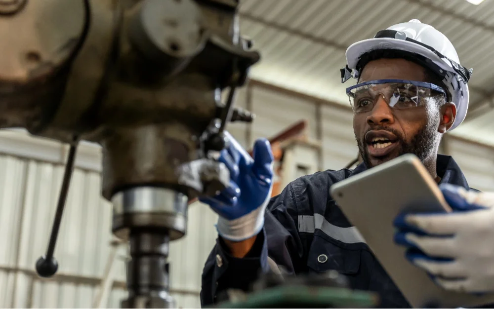 Technician following digital work instructions and a maintenance schedule on a tablet